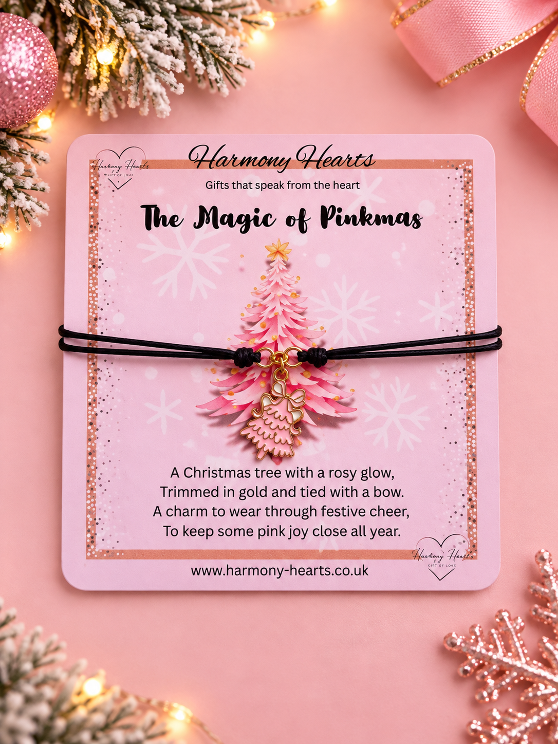 A pink Christmas-themed card from Harmony Hearts displaying a pink and gold Christmas tree on a pink background with festive decorations.