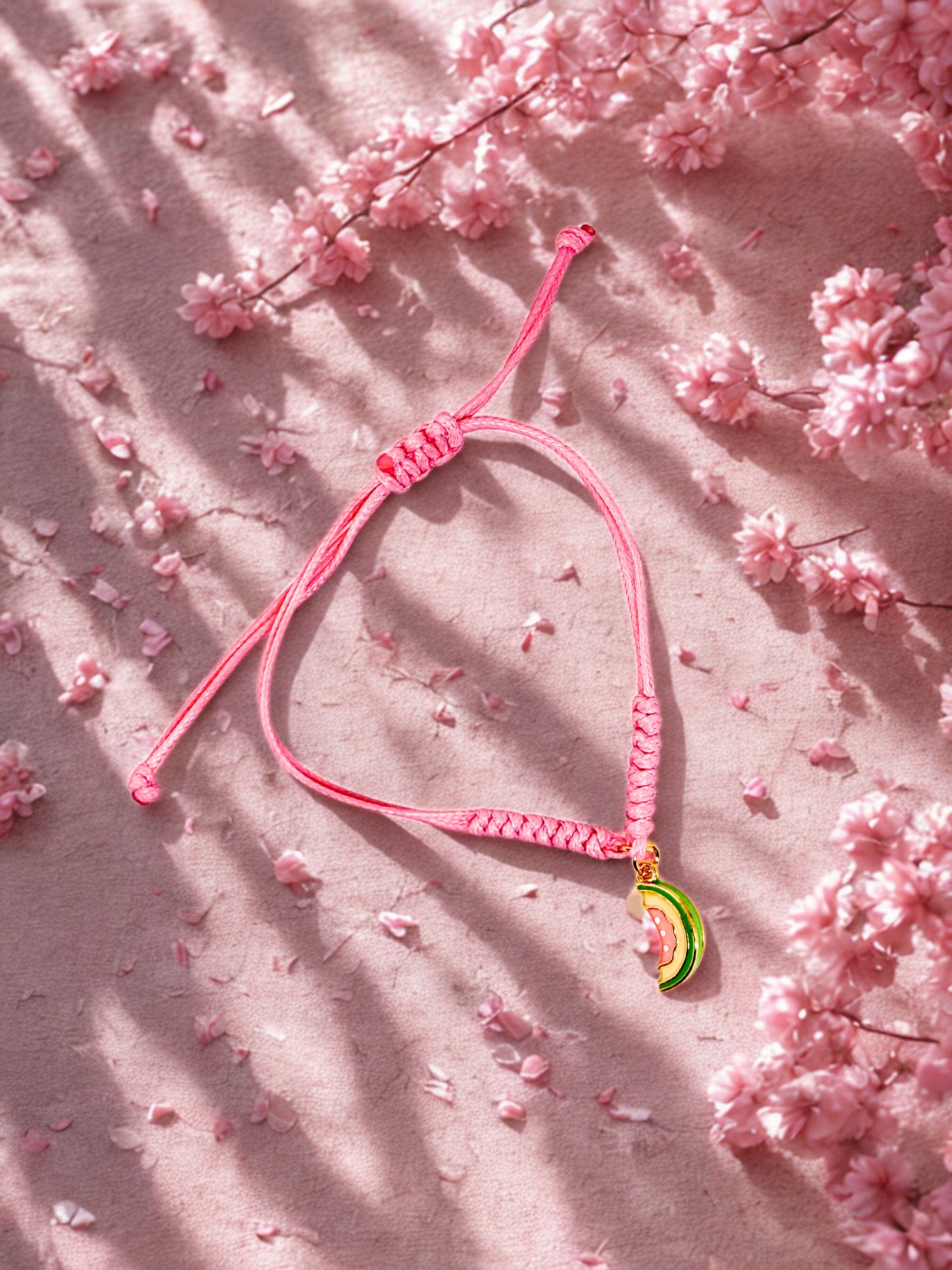 Pink cord bracelet with a papaya charm