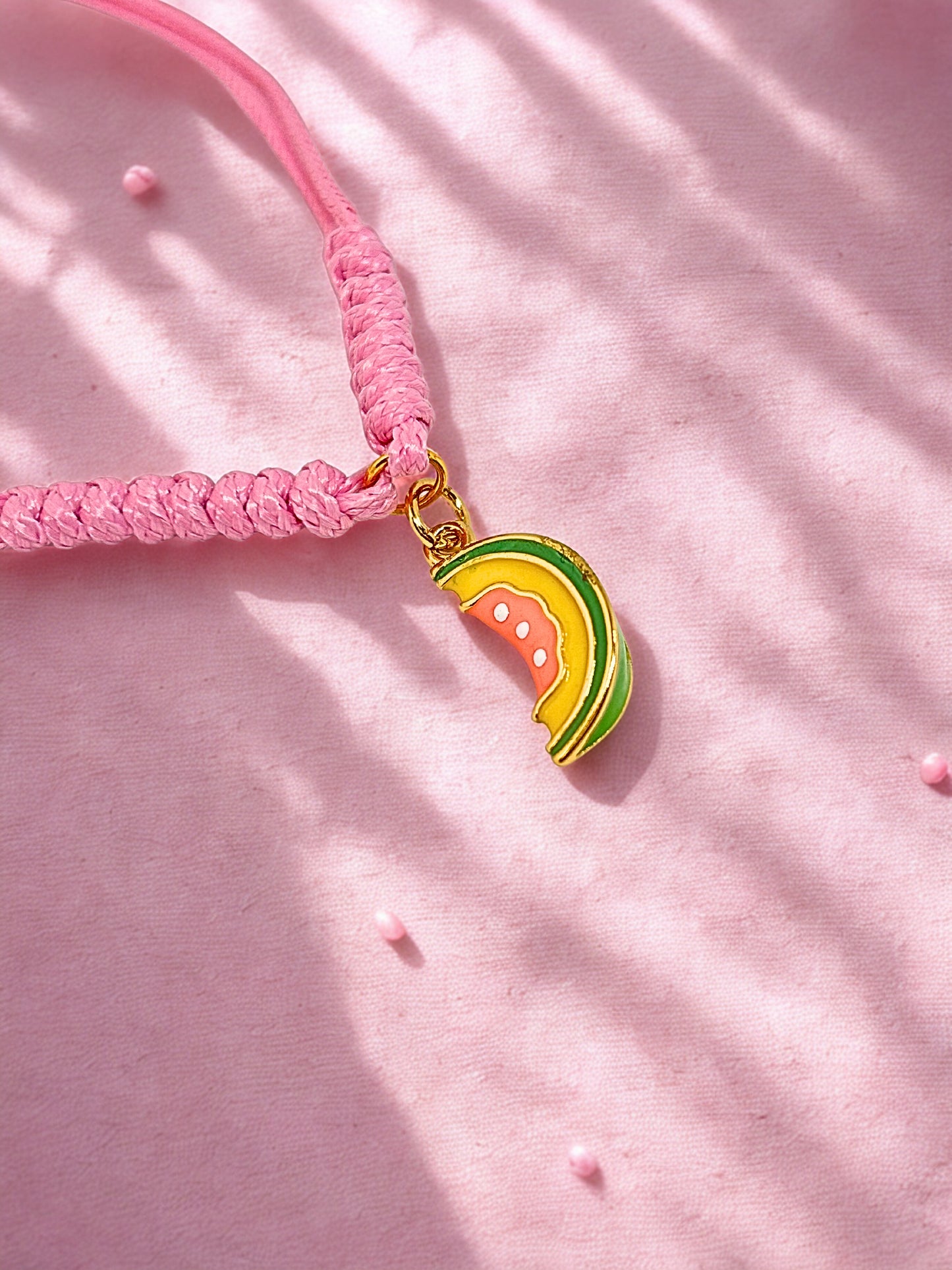 Pink cord bracelet with a papaya charm
