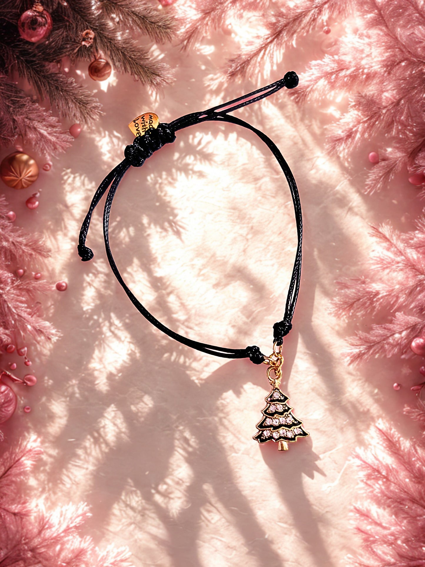Black and gold christmas tree charm on a black cord bracelet 
