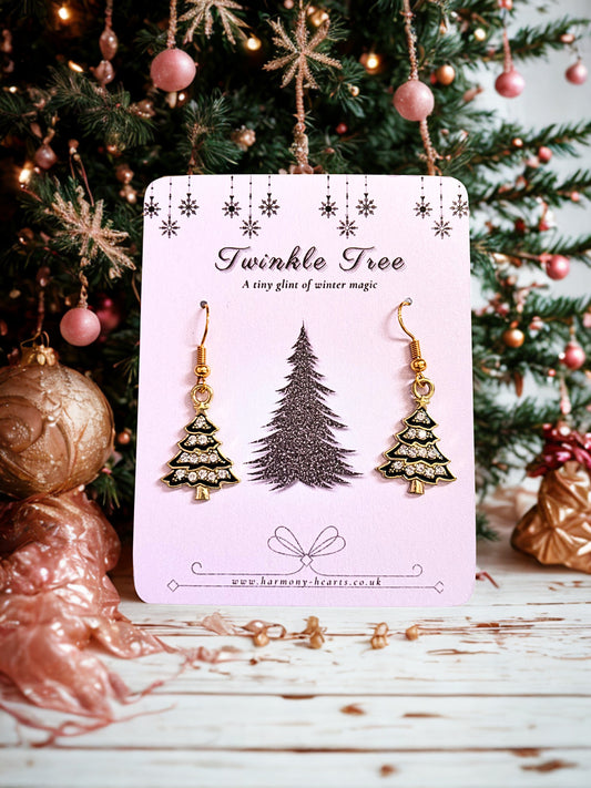 Black & gold Christmas tree earrings on a twinkle tree card under a Christmas tree