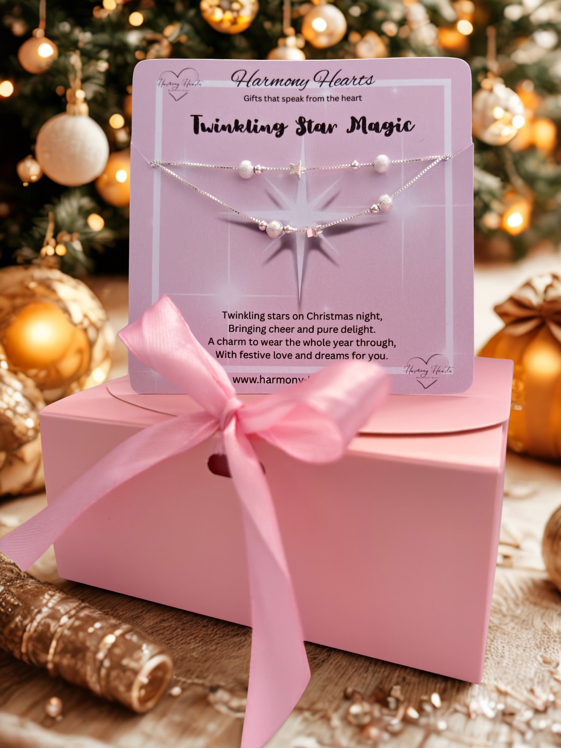 Bracelet packaging with pink ribbon and Christmas tree in the background
