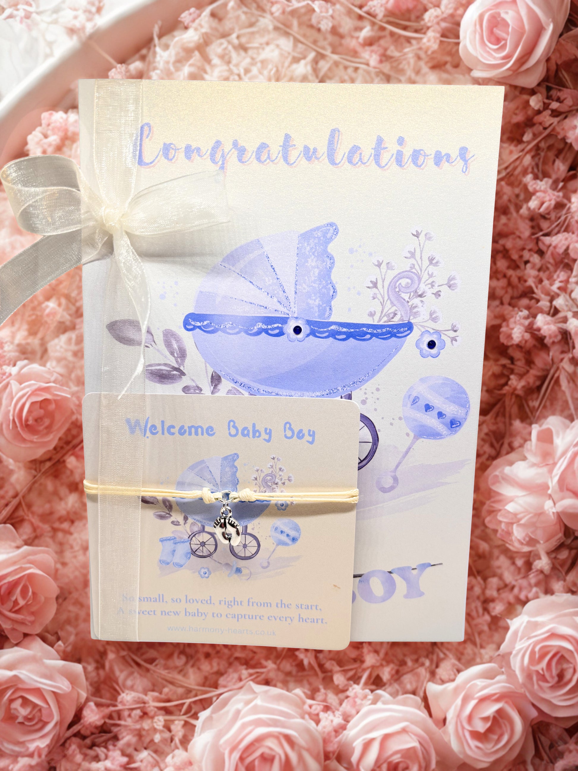 Baby boy baby shower card with a bracelet and a pram illustration on a pink floral background