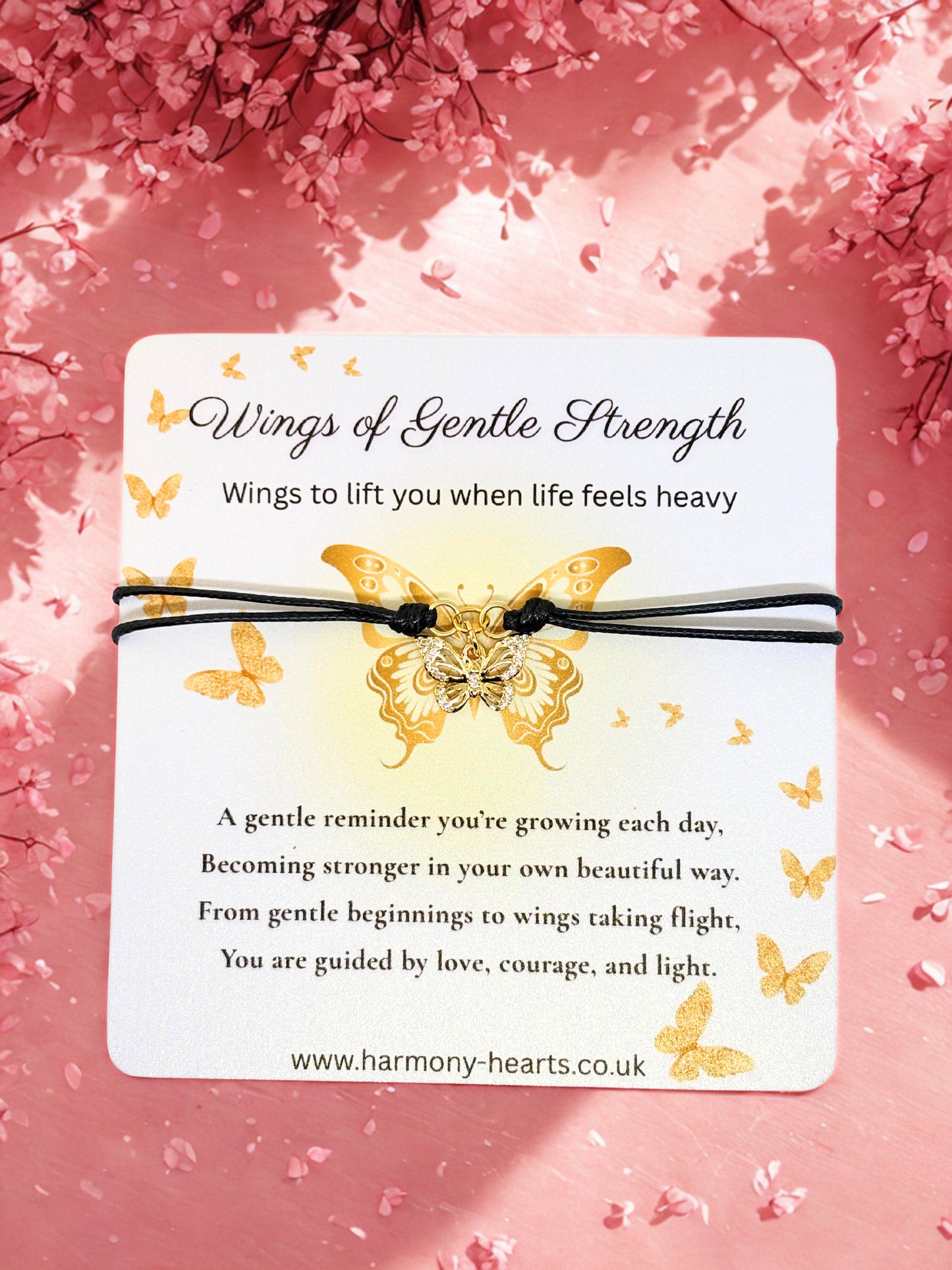 Butterfly bracelet with inspirational message on a pink floral background