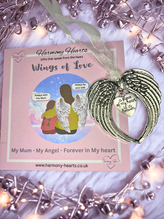 Angel wing ornament with sentimental card on a decorative background