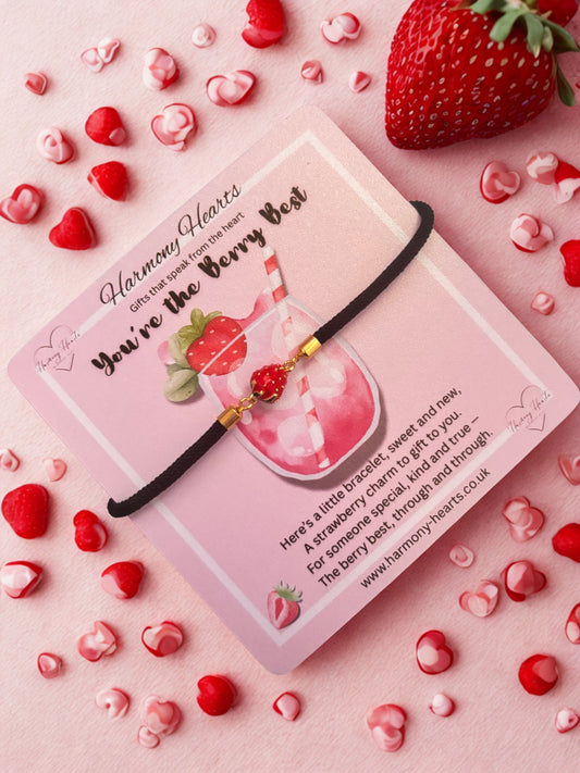 Strawberry-themed bracelet on a pink card with strawberries and hearts around